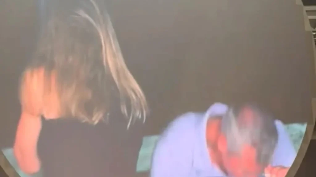 Coldplay concert kiss cam captures man and woman reacting with visible shock on stadium jumbotron.